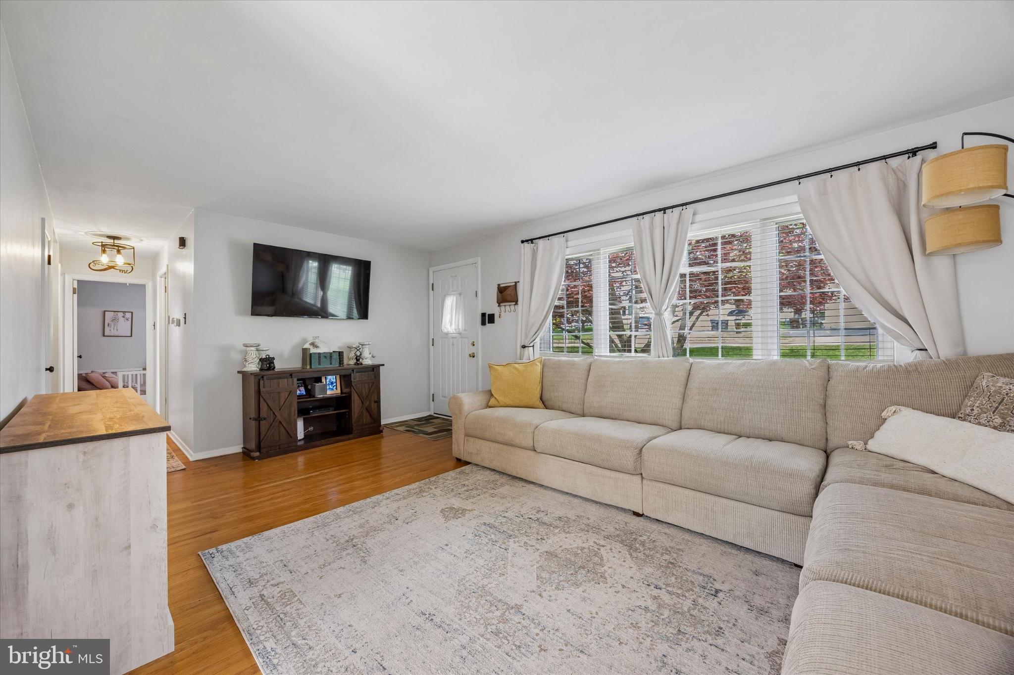 187 East Valley Forge Road King of Prussia, PA 19406 - Photo 2 of 16 a living room with furniture and a flat screen tv