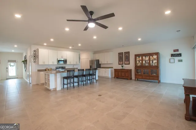 a view of a kitchen with furniture and a refrigerator