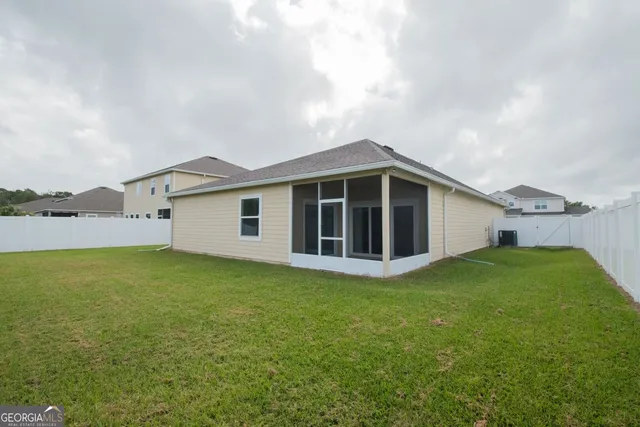 a view of a house with backyard porch and garden