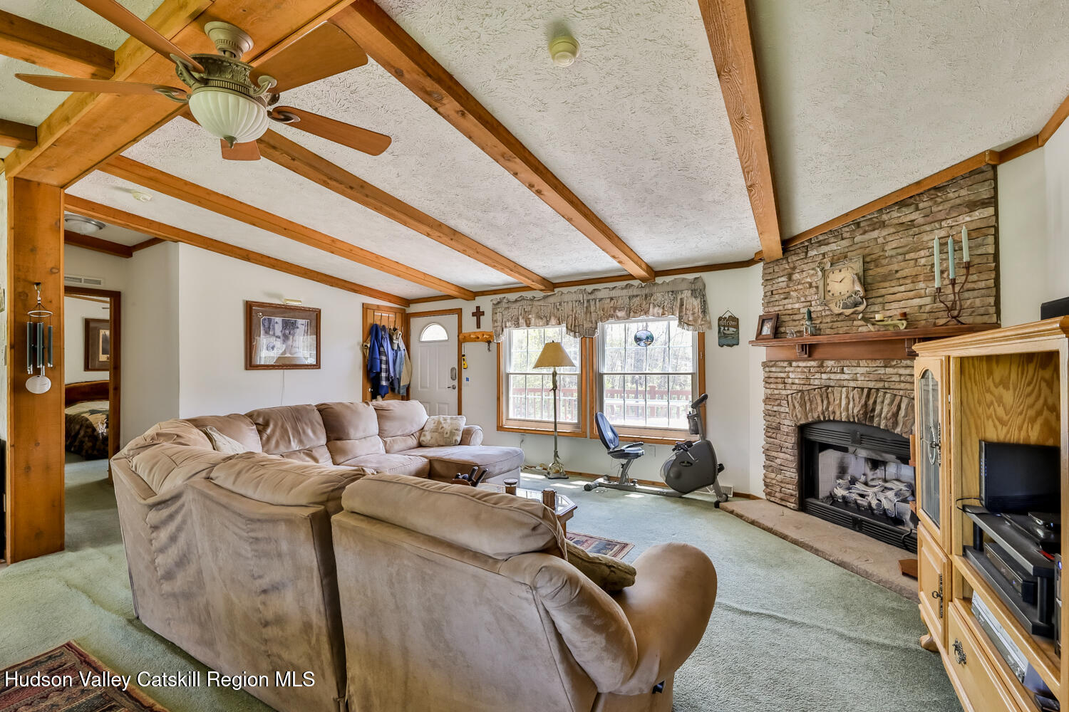 751 Mitchell Hollow Road Windham, NY 12496 - Photo 8 of 37 a living room with furniture a fireplace and a floor to ceiling window