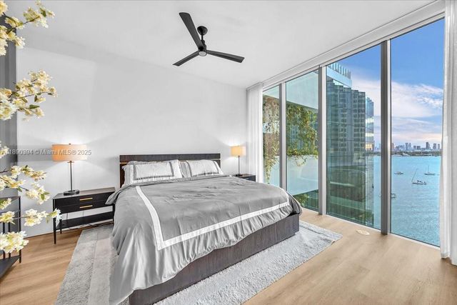 a bedroom with a large bed and a chandelier