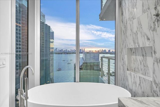 a view of a bathroom with a bathtub and shower