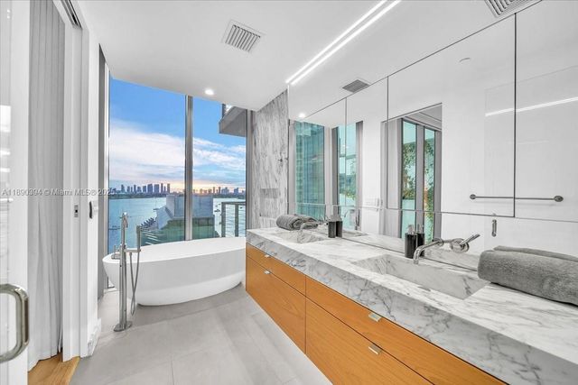 a spacious bathroom with sink and bathtub