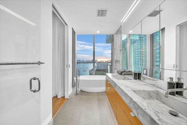 a spacious bathroom with a granite countertop sink and a large window