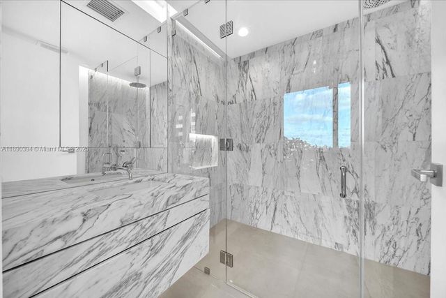 a bathroom with a bathtub and shower