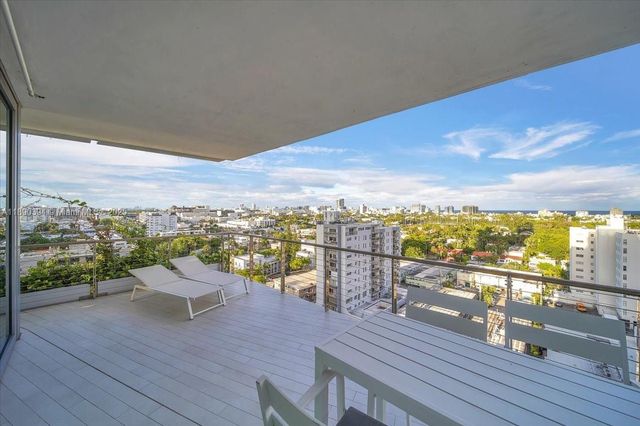 a view of a balcony with wooden floor
