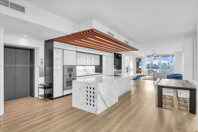 a view of living room kitchen with furniture and wooden floor