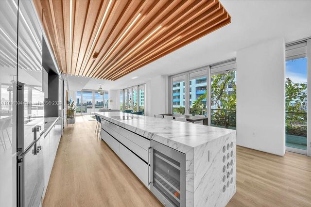 a living room with stainless steel appliances granite countertop furniture and a kitchen view