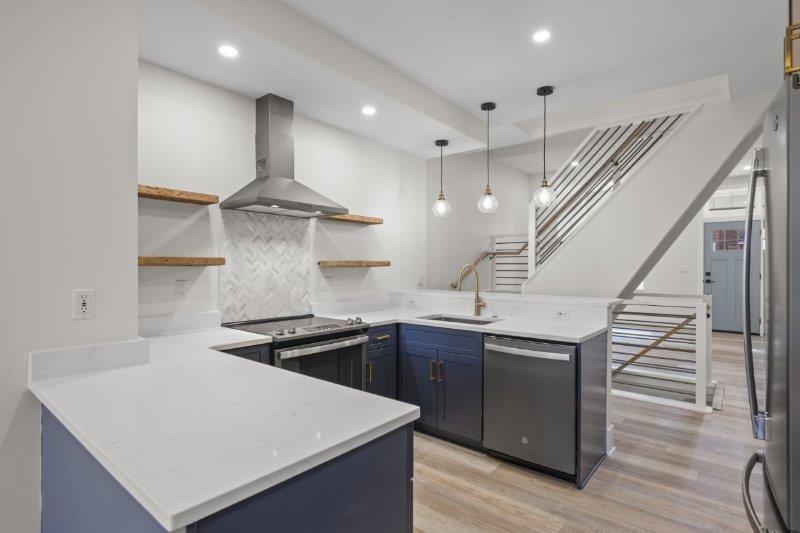 343 46th Street Pittsburgh, PA 15201 - Photo 10 of 40 a kitchen with stainless steel appliances granite countertop a sink a stove and a refrigerator