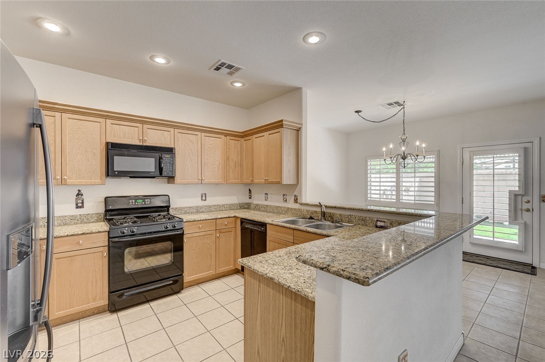 1479 Orange Jubilee Road Henderson, NV 89014 - Photo 12 of 36 A well-appointed kitchen features ample cabinetry, granite counters, and integrated appliances.