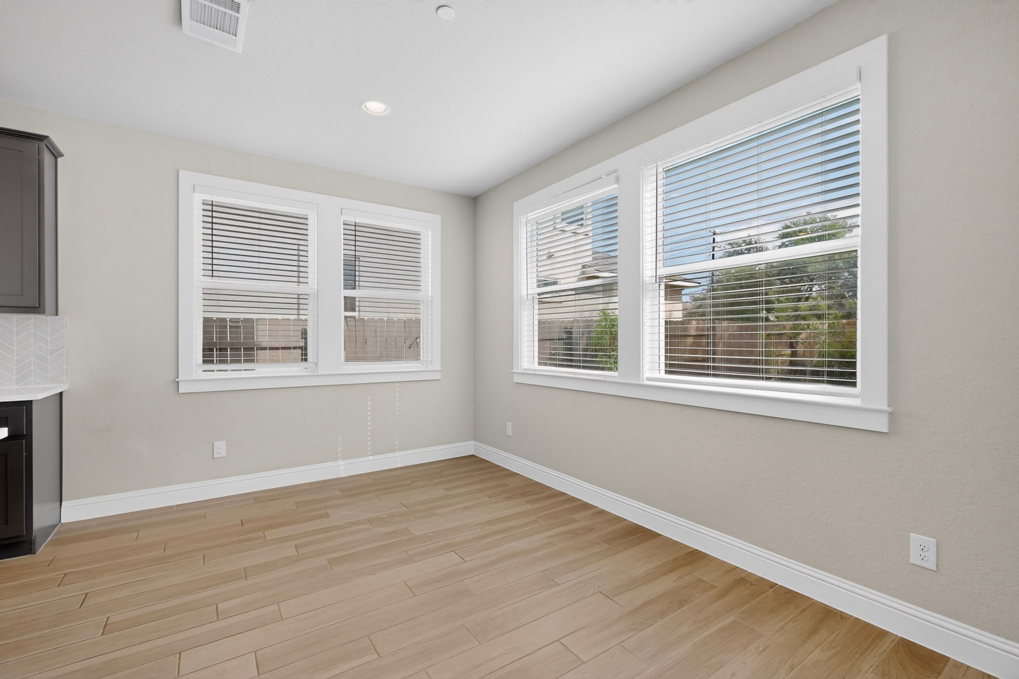 2605 Sam Bass Road, Unit 9 Round Rock, TX 78681 - Photo 12 of 38 Well-lit room with warm flooring and multiple windows offers a comfortable living area.