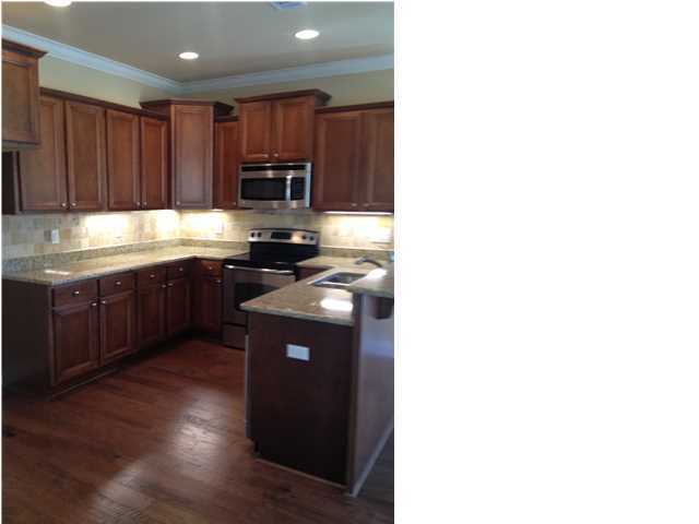 20 Topside Drive Inlet Beach, FL 32461 - Photo 3 of 13 a kitchen with wooden cabinets a sink and a stove