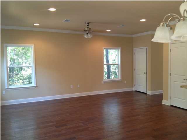 20 Topside Drive Inlet Beach, FL 32461 - Photo 5 of 13 an empty room with wooden floor a ceiling fan and windows