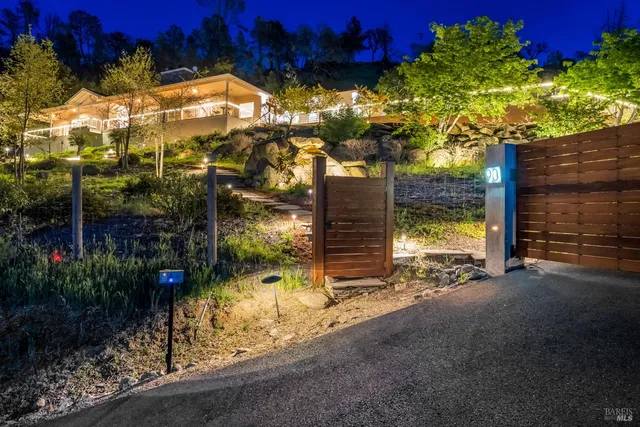 a living room with furniture a flat screen tv and a large window