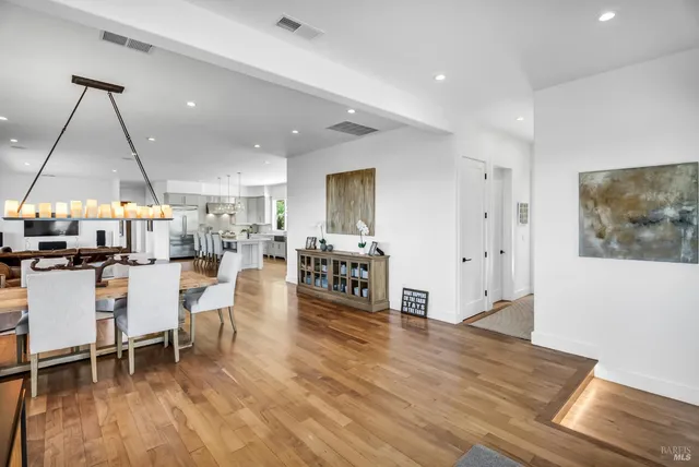 a living room with fireplace furniture and a wooden floor
