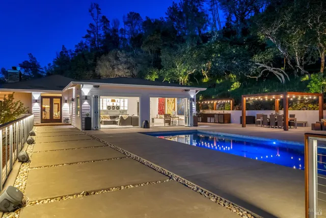 a view of swimming pool with outdoor seating and city view
