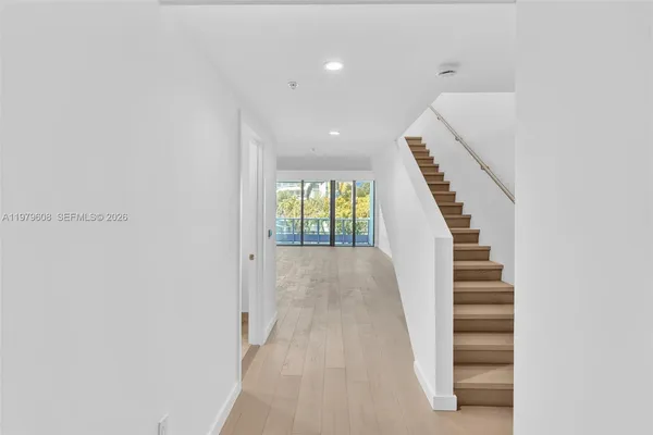 a view of entryway and hall with wooden floor