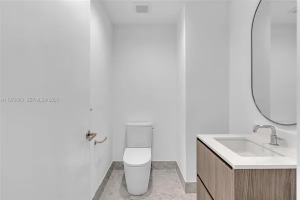 a bathroom with a sink toilet and vanity