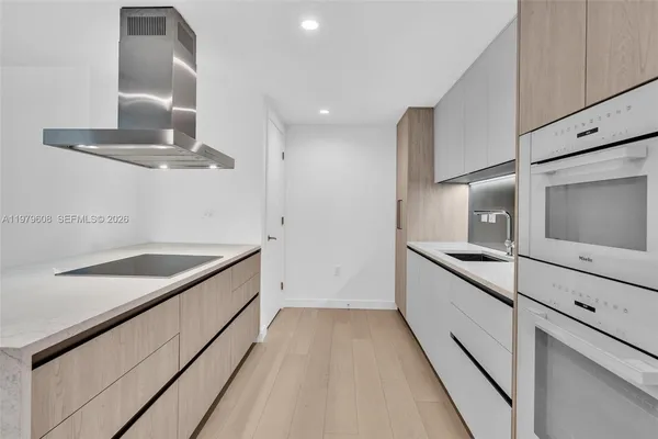 a kitchen with stainless steel appliances granite countertop a sink and a stove