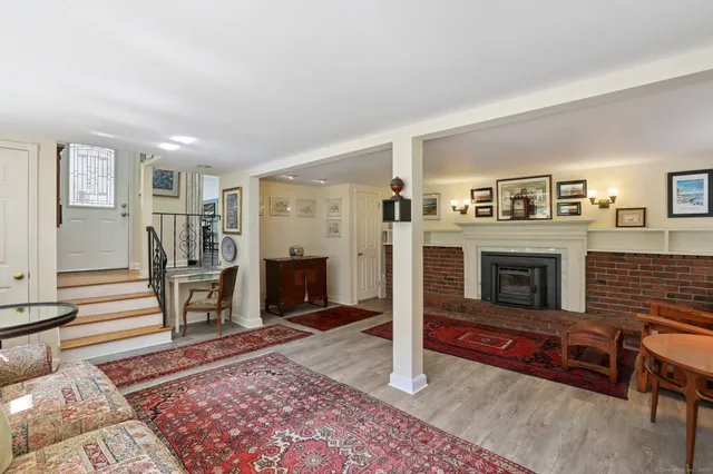 a living room with furniture flat screen tv and a fireplace