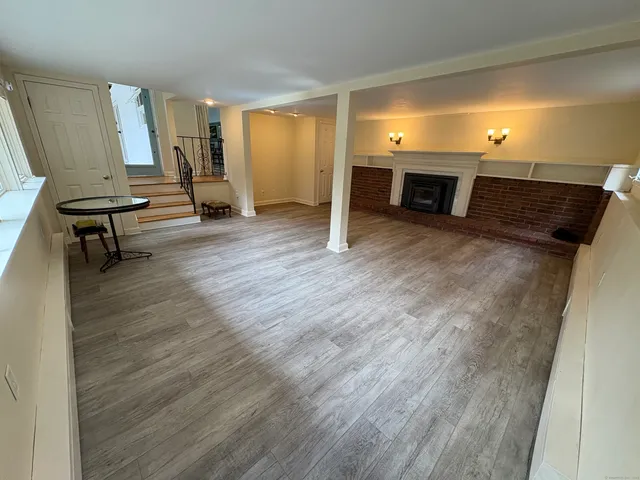 a view of a room with wooden floor