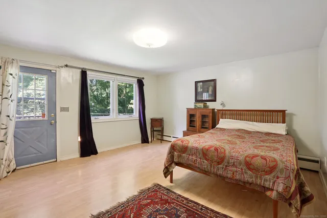 a bedroom with a bed and a large window