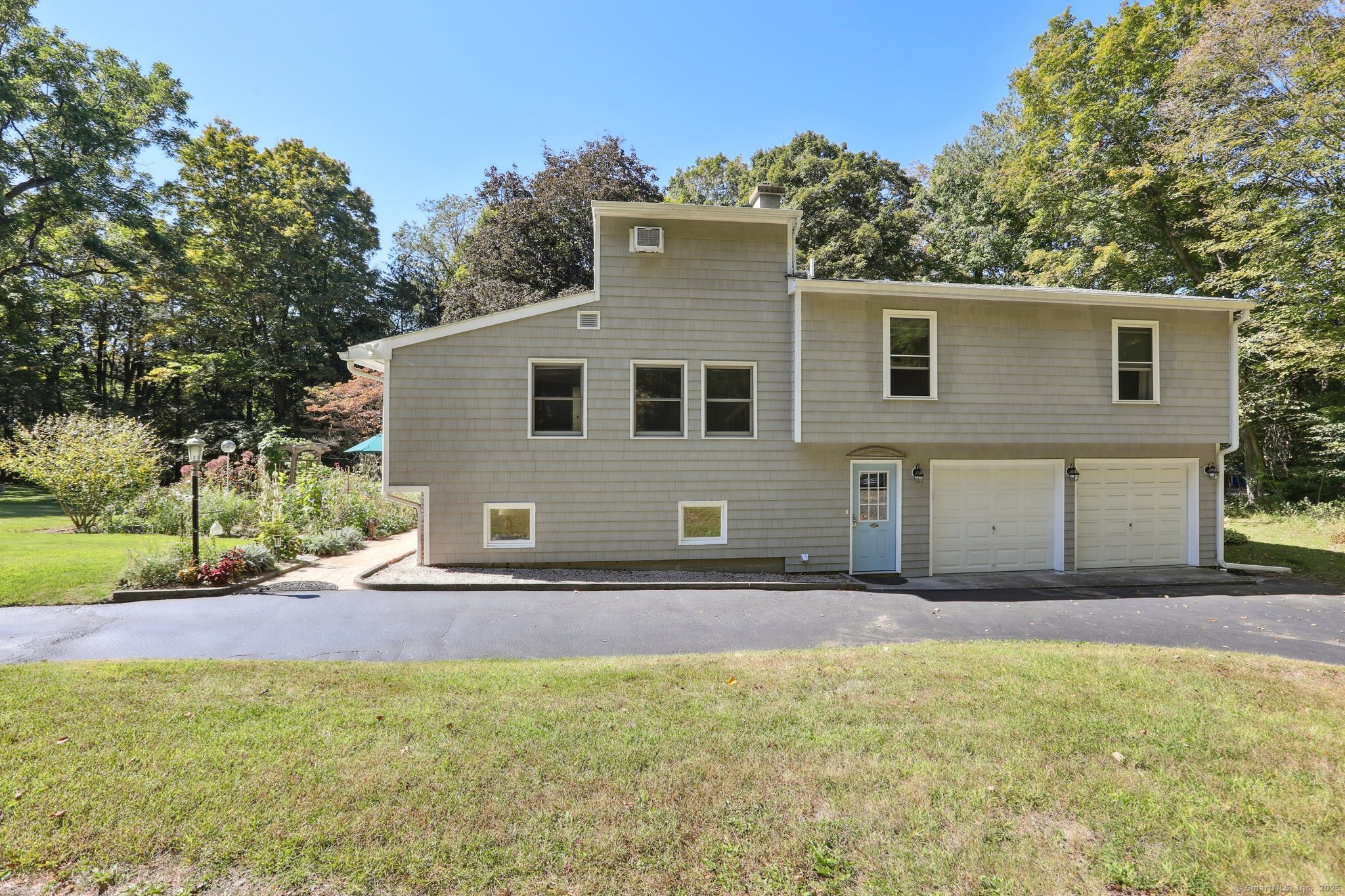 62 Walnut Hill Road Bethel, CT 06801 - Photo 31 of 39 a front view of a house with a yard and garage