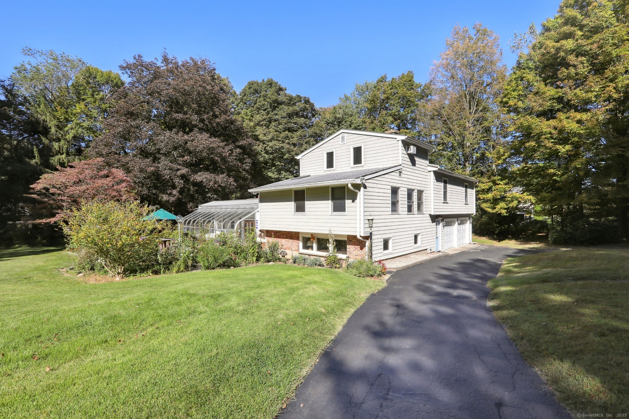 62 Walnut Hill Road Bethel, CT 06801 - Photo 33 of 39 a view of a white house with a big yard and large trees