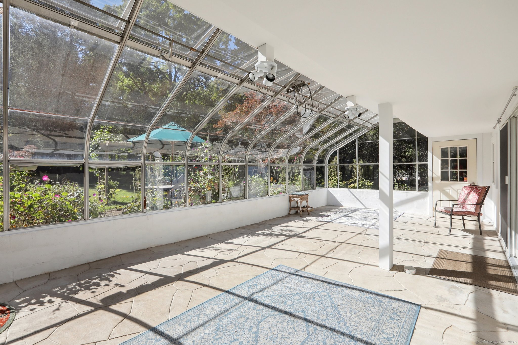 62 Walnut Hill Road Bethel, CT 06801 - Photo 6 of 39 a view of a porch with a table and chairs
