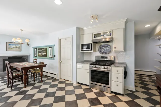 a kitchen with a stove a sink and a refrigerator