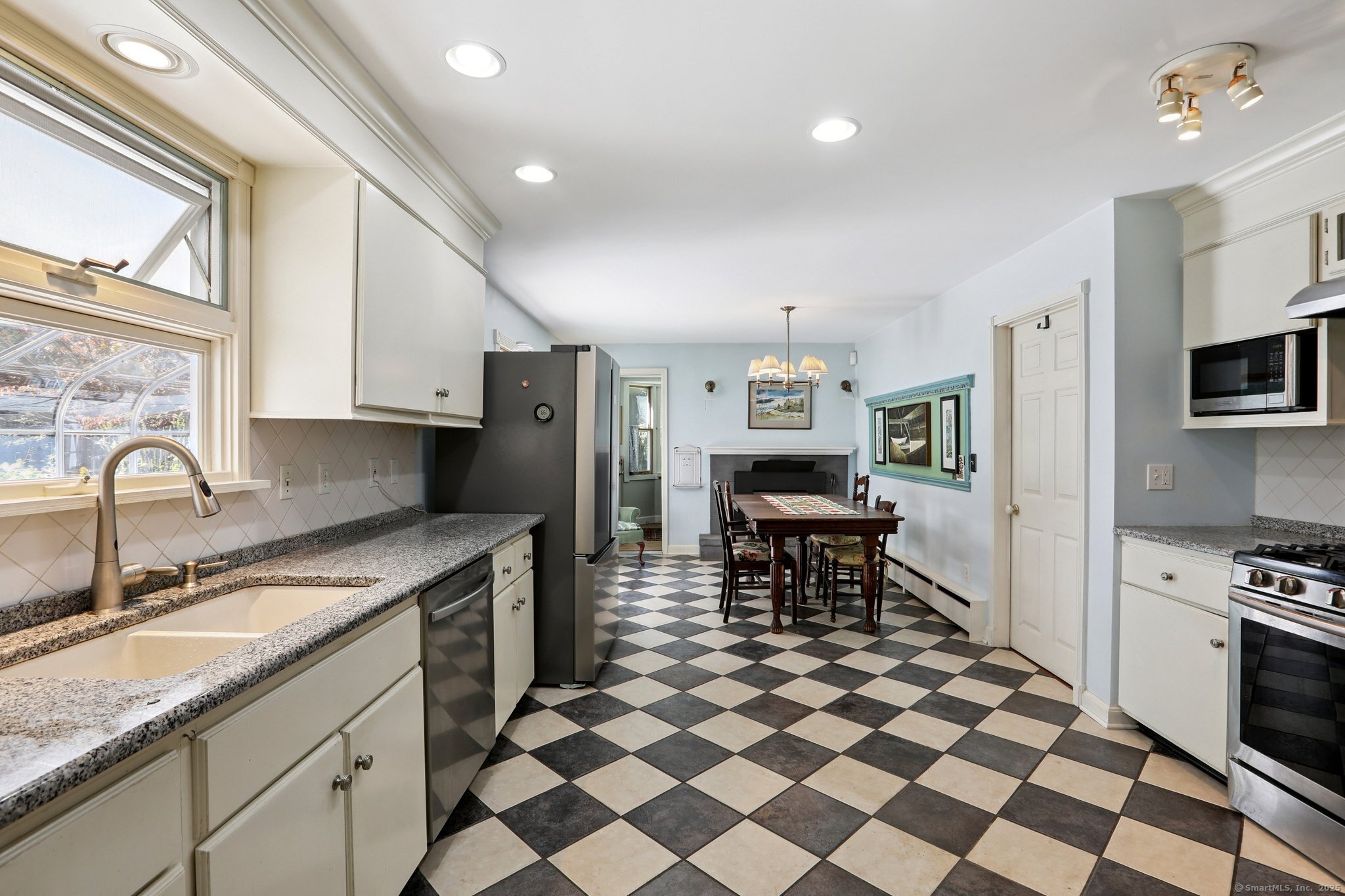 62 Walnut Hill Road Bethel, CT 06801 - Photo 9 of 39 a kitchen with stainless steel appliances granite countertop a sink a stove a refrigerator and island with wooden cabinets