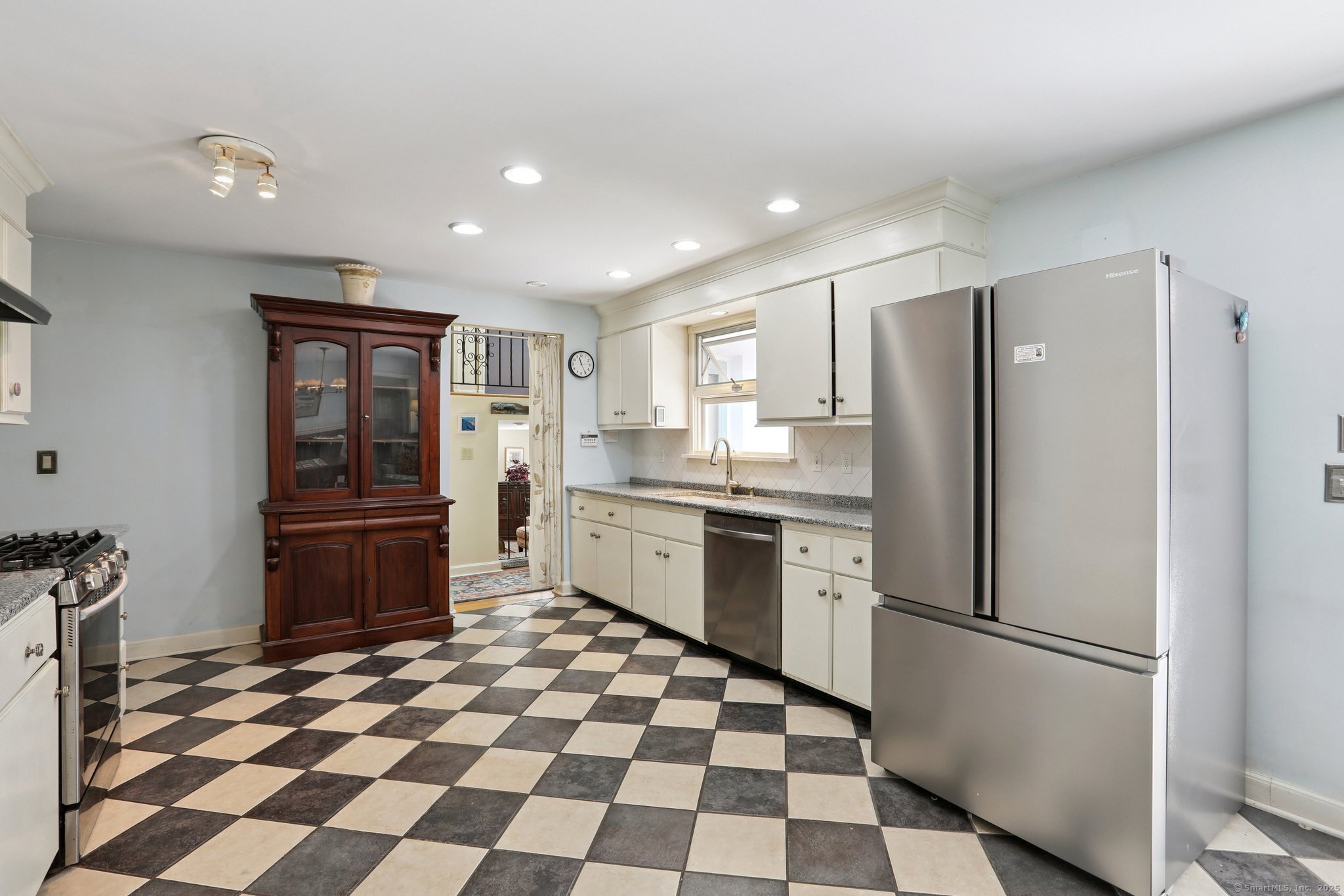 62 Walnut Hill Road Bethel, CT 06801 - Photo 10 of 39 a kitchen with a refrigerator a sink and a stove top oven with wooden floor