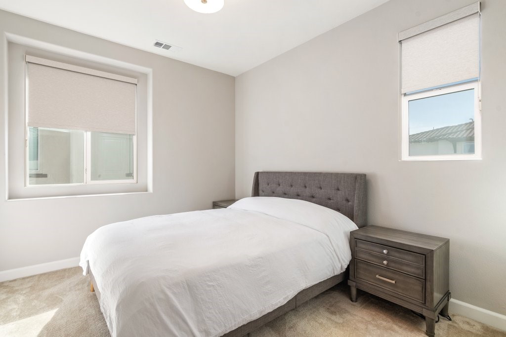 3573 Conner Way Oceanside, CA 92056 - Photo 18 of 25 a large bed sitting in a bedroom next to a window