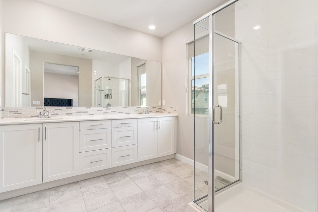 3573 Conner Way Oceanside, CA 92056 - Photo 21 of 25 a spacious bathroom with a shower sink and mirror