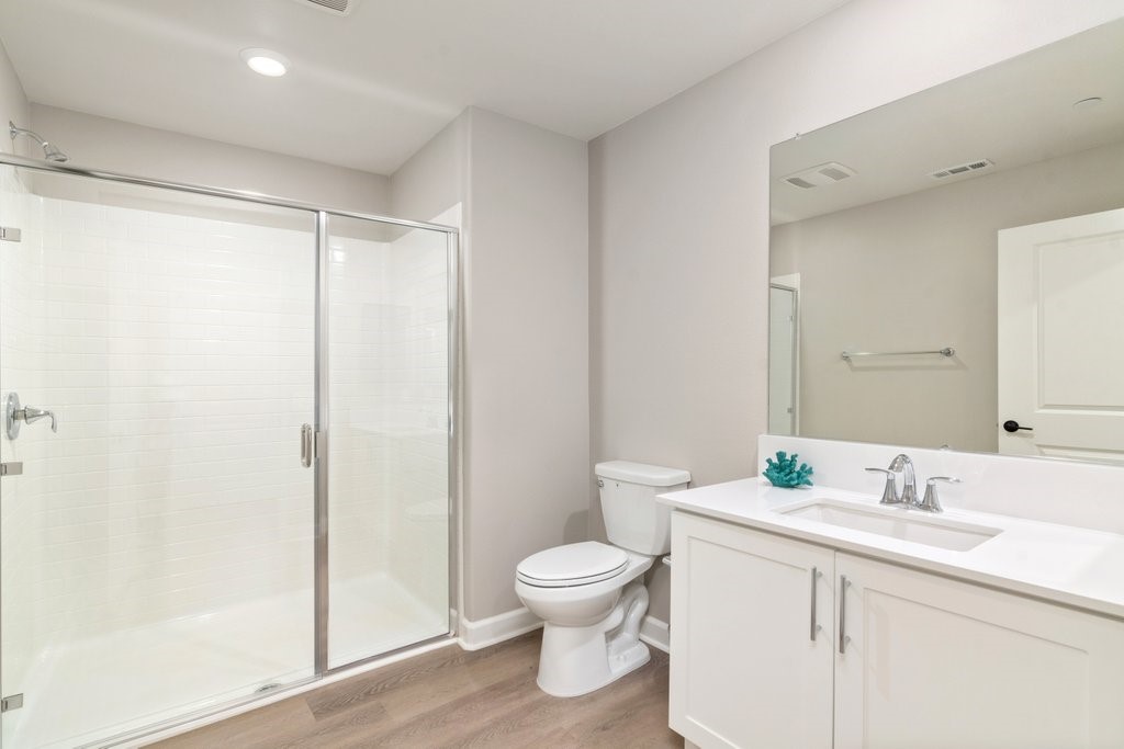 3573 Conner Way Oceanside, CA 92056 - Photo 6 of 25 a bathroom with a toilet a sink and a mirror
