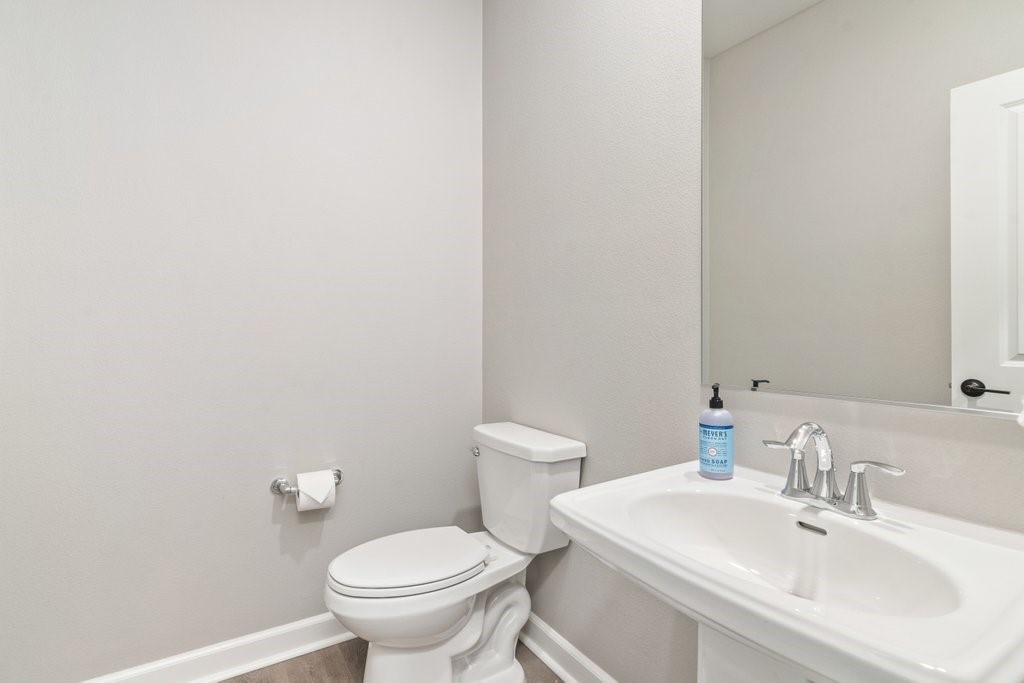 3573 Conner Way Oceanside, CA 92056 - Photo 10 of 25 a bathroom with a sink a toilet and a mirror