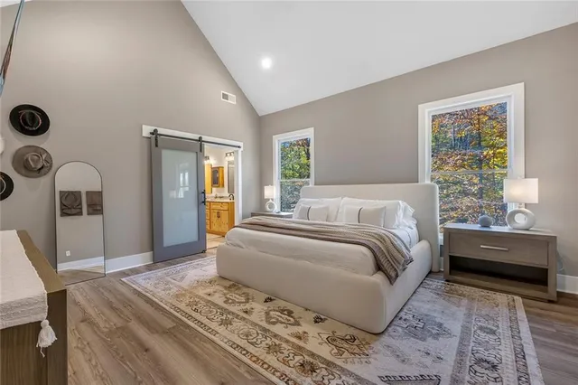 a bedroom with a bed and a view of living room