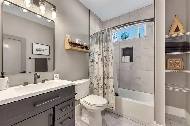 a bedroom with bed and a chandelier