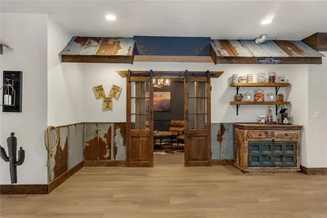 a bedroom with bed and a chandelier