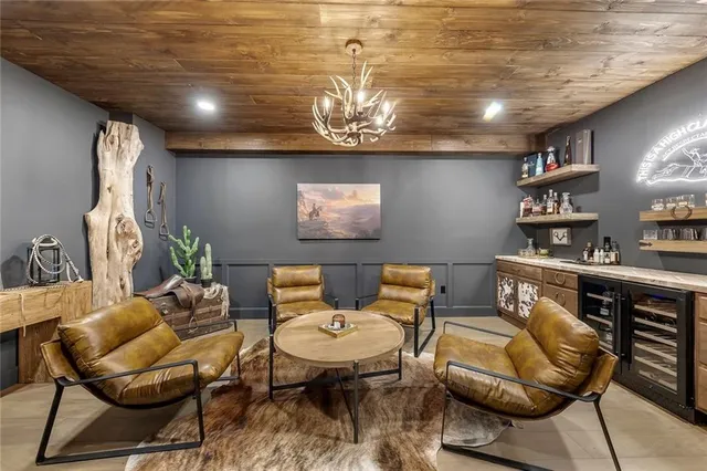 a bedroom with a large bed and a chandelier