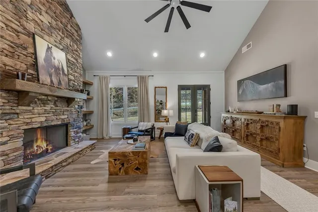 a living room with furniture fireplace and flat screen tv