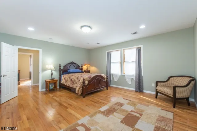 a spacious bedroom with a bed and a window