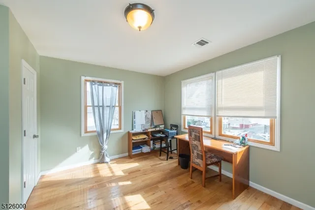 a view of a workspace with furniture and a window