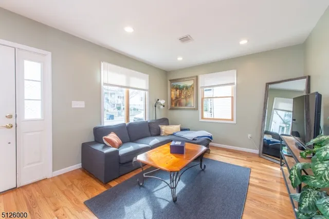 a living room with furniture a window and a table