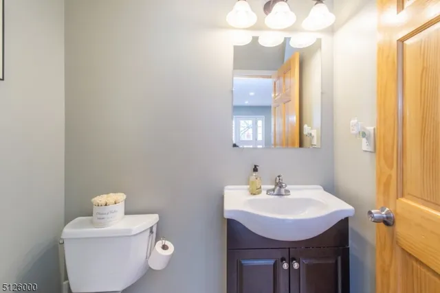 a bathroom with a sink toilet and vanity