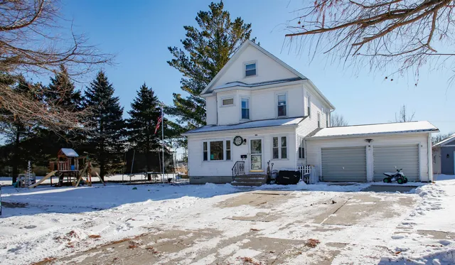a view of a house with snow on the road