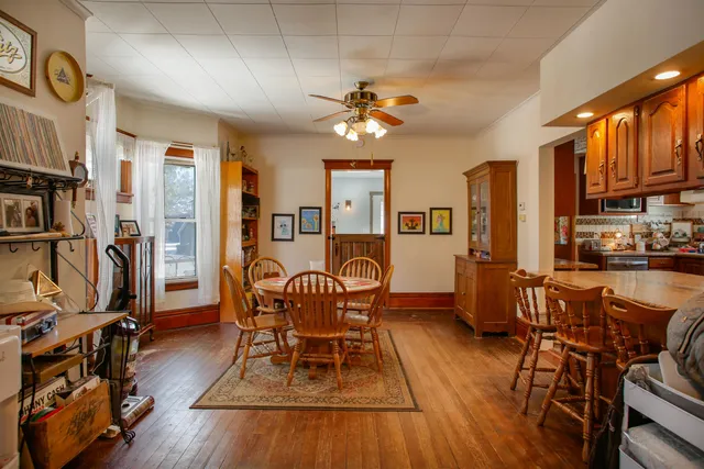 a dining room with furniture entryway and wooden floor