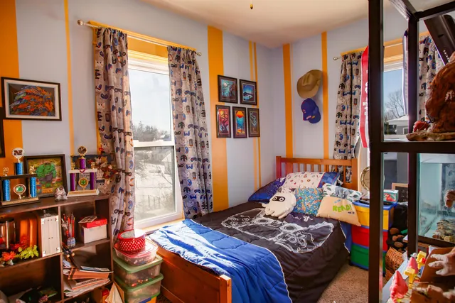 a bedroom with a bed and a book shelf