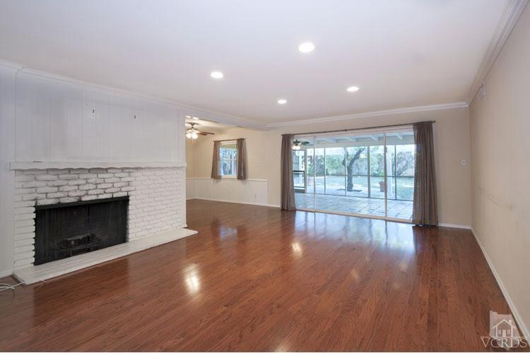 4739 Libbit Avenue Encino, CA 91436 - Photo 2 of 13 a view of an empty room with wooden floor and a fireplace