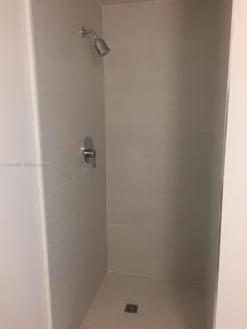 a view of an empty room with a sliding door and glass window